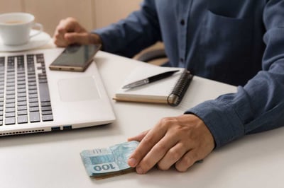 Desk with Laptop money and pen