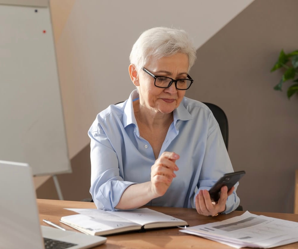 Elderly woman watching a phone