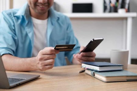Man-holding-id-card-and-phone