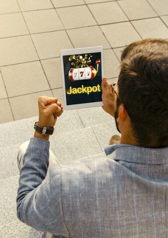 Man-holding-tablet-with-online-gambling