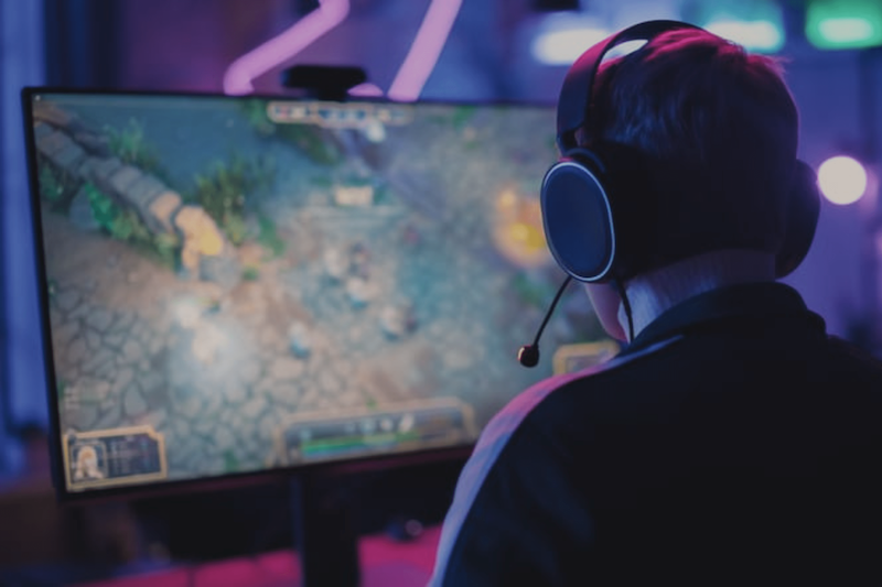 Man gaming on Computer Screen wearing Headphones