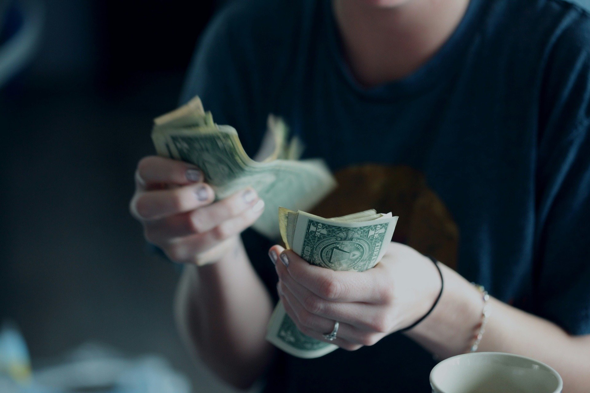 Person counting money in their hands