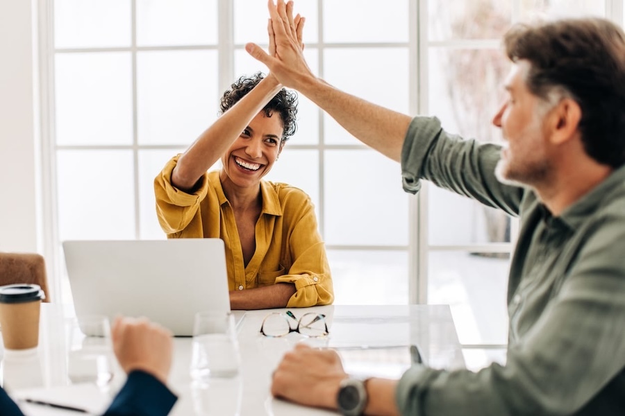 Two colleagues are clapping from joy