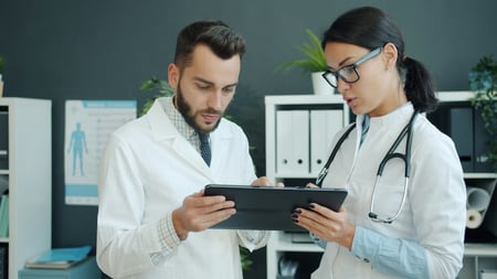 two doctors with digital pacient files