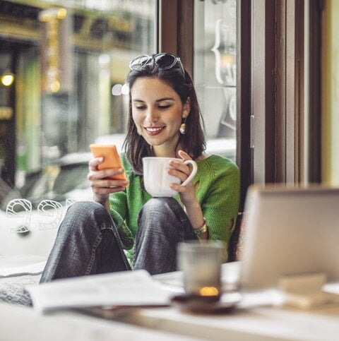 Woman with coffee and smartphone