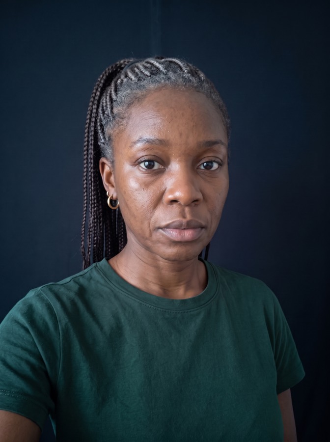 AI-generated fictional person: a woman with braids at a claim step, her selfie edited to age her thirty years