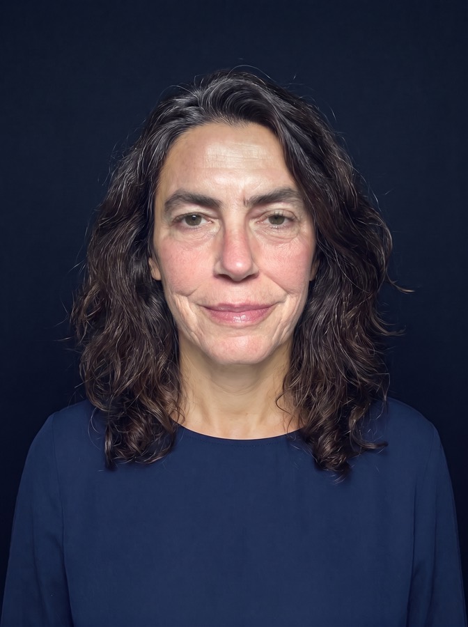 AI-generated fictional person: a woman in a blue blouse at a periodic re-check, her selfie carrying an older woman's face