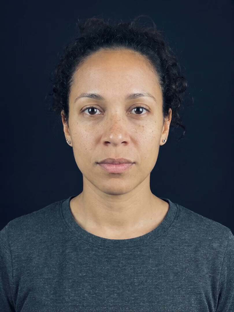 AI-generated fictional person: a woman inside an onboarding camera frame, face-swap manipulation, the scan sweeping her face before the verdict Synthetic