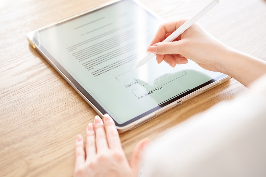 Person-signing-on-tablet