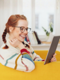 Young woman reading digitally